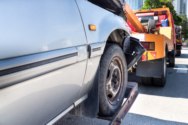 Tow truck towing a broken down car in emergency